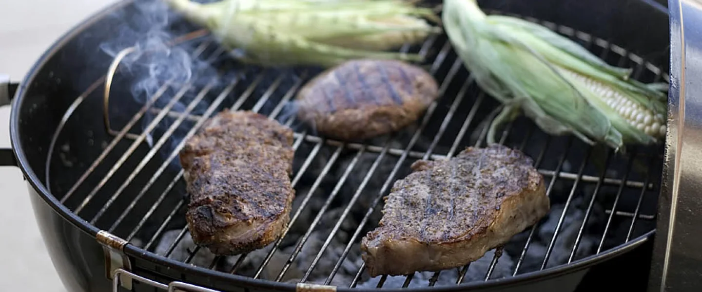Beef and corn on the cob on a charcoal barbecue grill. Credit: Brian Chu via Wikimedia Commons.