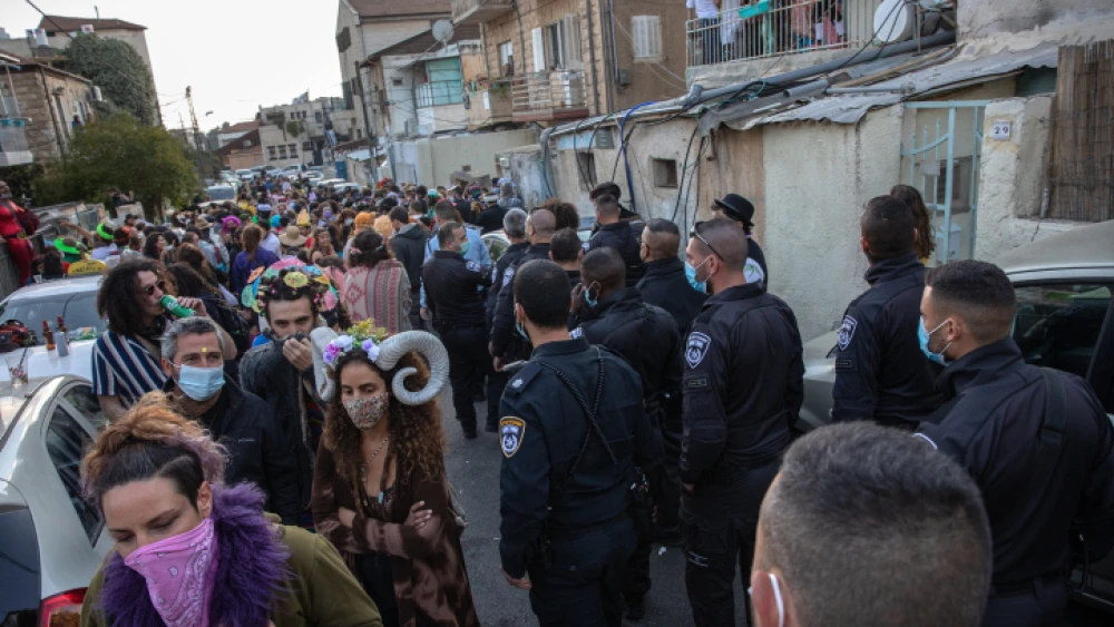 Israeli police officers close a Purim street party in Jerusalem to prevent the spread of COVID-19, Feb. 28, 2021. Photo by Olivier Fitoussi/Flash90.