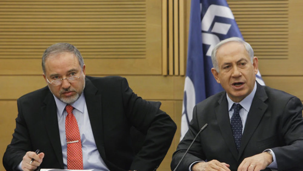 Israeli Prime Minister Benjamin Netanyahu (right) and then Foreign Minister Avigdor Lieberman at a meeting of the Likud-Beiteinu faction in the Knesset on March 11, 2014.