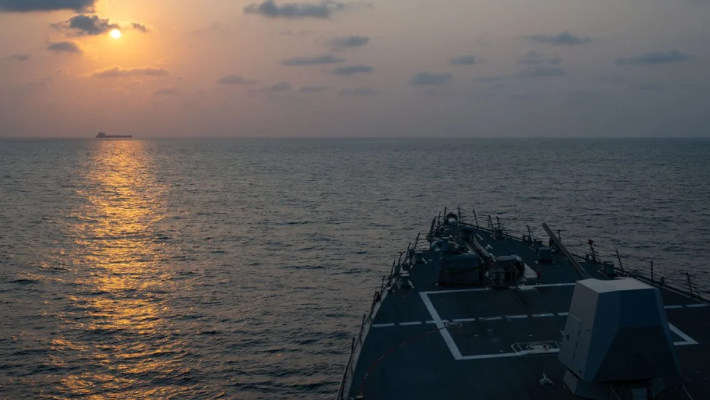 Guided-missile destroyer USS Pinckney (DDG 91) observes a merchant vessel while on patrol enforcing the U.S. blockade against Iran, May 4, 2026. Credit: U.S. Central Command.