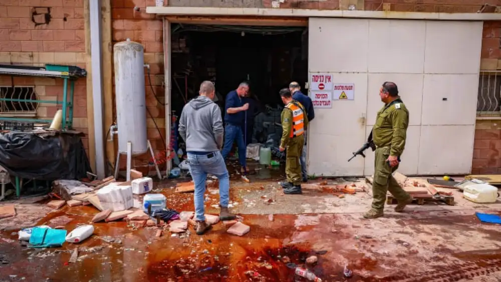 Israeli security forces survey the damage in Kiryat Shmona following a hit by a rocket from Lebanon, March 27, 2024. Photo by David Cohen/Flash90