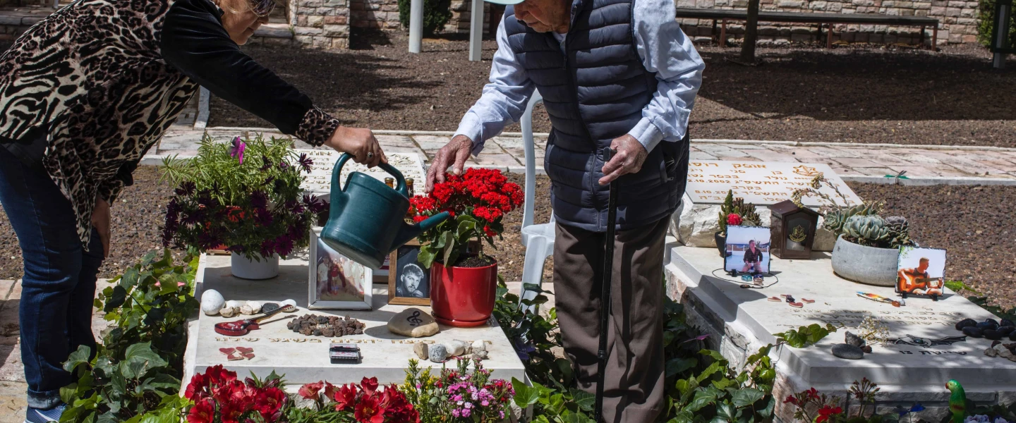 Yaakov Lubinewski, 99, tends the graves of two Israeli soldiers from his town killed during Hamas's Oct. 7 massacre, March 26, 2024. Credit: Rina Castelnuovo.