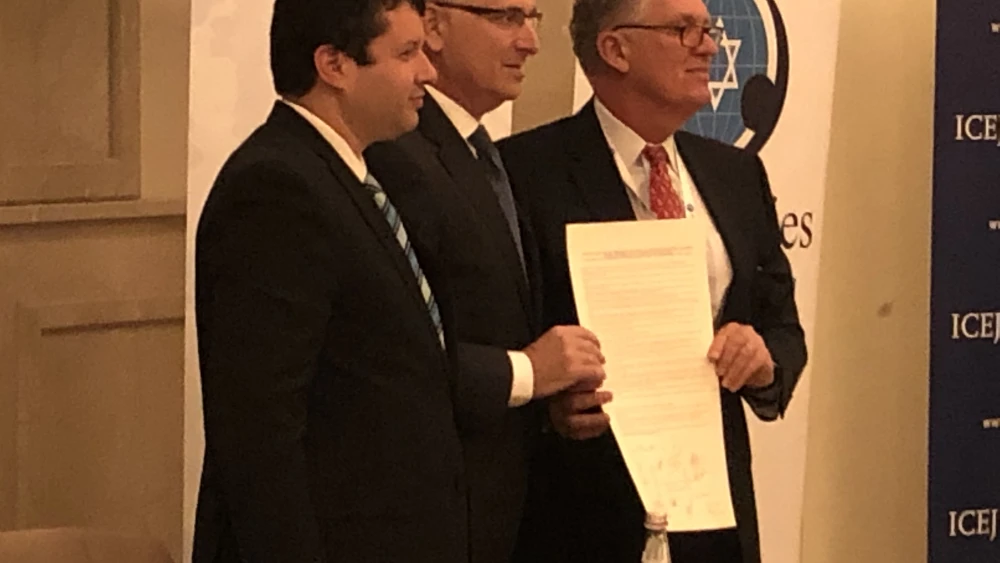 Israel Allies Foundation President Josh Reinstein (left), Knesset member Gideon Sa’ar (center) and IAF chairman of the board Dr. Dave Weston hold a pro-Israel resolution signed by parliamentarians worldwide at their annual conference in Jerusalem, Dec. 10, 2019. Photo by Josh Hasten.