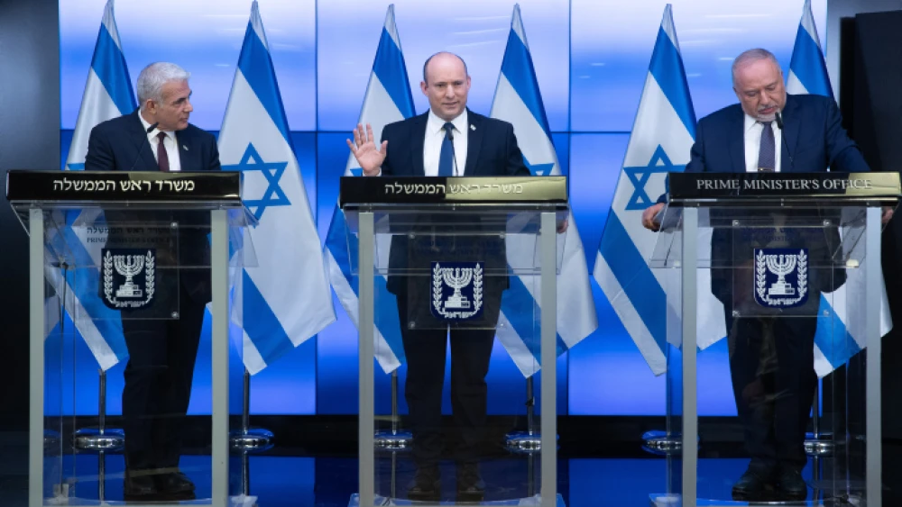 Israeli Prime Minister Naftali Bennett (center), Foreign Affairs Minister Yair Lapid (left) and Finance Minister Avigdor Liberman give a press conference in Jerusalem on Nov. 6, 2021. Photo by Ohad Zwigenberg/POOL.