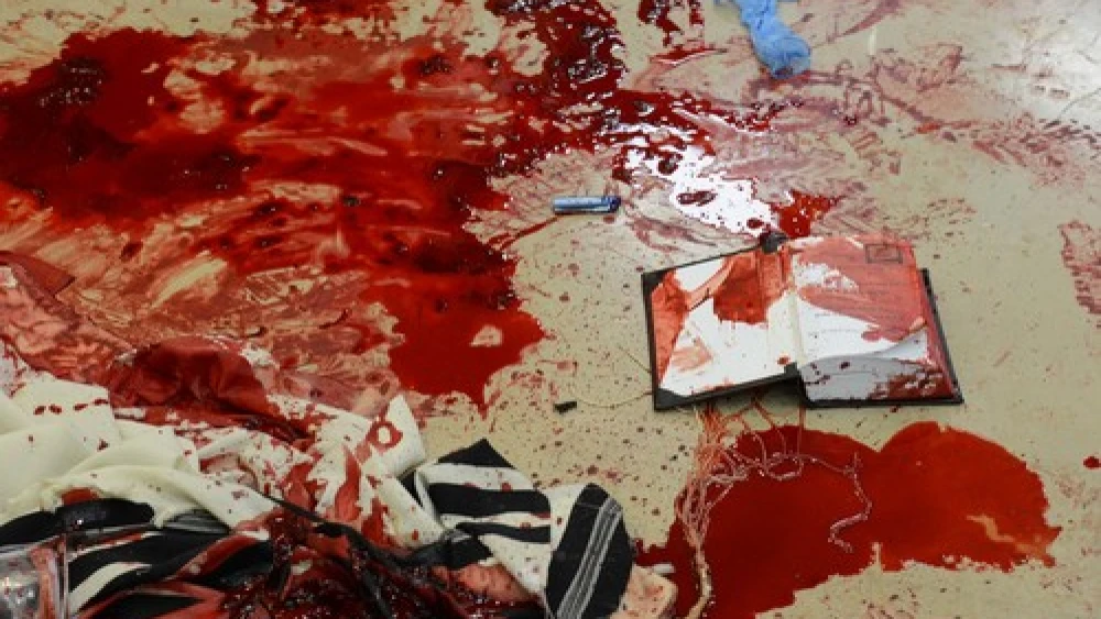 Blood on prayer shawls and a siddur inside the Kehilat Bnei Torah synagogue in Jerusalem following the terrorist attack that took place there on Nov. 18, 2014. Cerdit: Kobi Gideon/GPO/Flash90.
