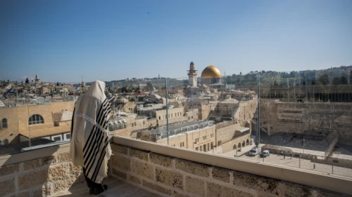 A man covers himself with a prayer shawl while praying near the Western Wall, Judaism's holiest prayer site, in Jerusalem's Old City, during the Passover priestly blessing service while the country grapples with the coronavirus pandemic, on April 12, 2020. Photo by Yonatan Sindel/Flash90.