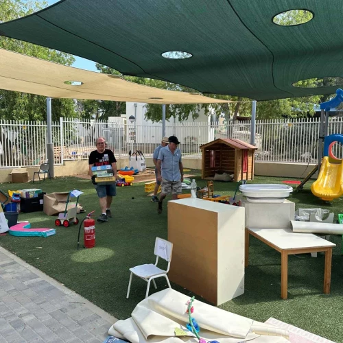 Volunteers set up a kindergarten playground at Kibbutz Nir Am, Aug. 20, 2024. Photo by Debbie Dash.