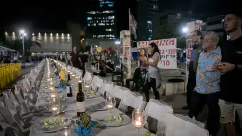 A Shabbat table with 240 empty seats, representing the 240 civilians held hostage by Hamas terrorists in Gaza, at the "Hostages' Square" outside Israeli Defense Ministry headquarters in Tel Aviv, Nov. 13, 2023. Photo by Miriam Alster/Flash90.