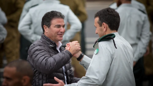 Director of the Mossad Yossi Cohen (left) greets outgoing Israel Defense Forces Chief of Intelligence Maj. Gen. Herzi Halevy at the Glilot military base near Tel Aviv, March 28, 2018. Photo by Miriam Alster/Flash90.