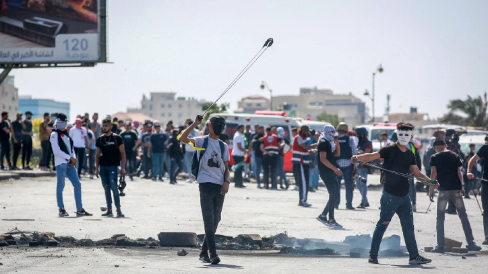 Palestinians clash with Israeli soldiers during a protest near Ramallah in the West Bank to mark the anniversary of the “nakba,” the “catastrophe” of Israel's creation in 1948, on May 15, 2018. Photo by Flash90.