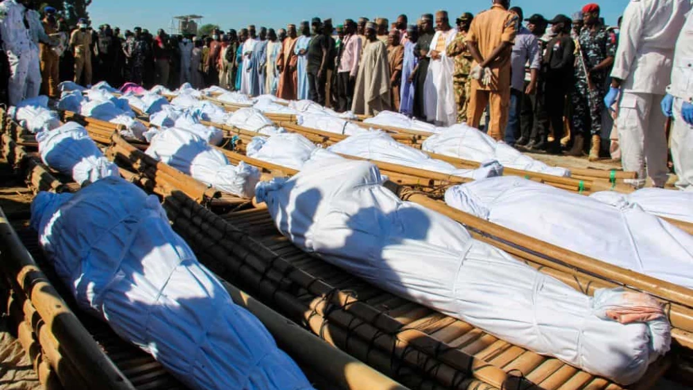 Mourners in Zabarmari, Nigeria, attend the funeral of 43 farm workers, who were killed by Islamist Boko Haram terrorists, on Nov. 29, 2020. Credit: Audu Marte/AFP via Getty Images.