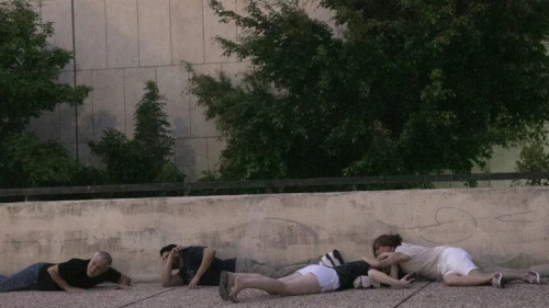 Israelis take cover as a rocket warning siren sounds in "Hostage Square" outside the Tel Aviv Museum of Art, Oct. 28, 2023. Photo by Miriam Alster/Flash90.