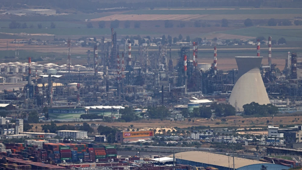 Smoke rises over Haifa’s oil refinery on June 15, 2025, after it was reportedly damaged in an overnight Iranian missile attack. Photo by Ahmad Gharabli/AFP via Getty Images.