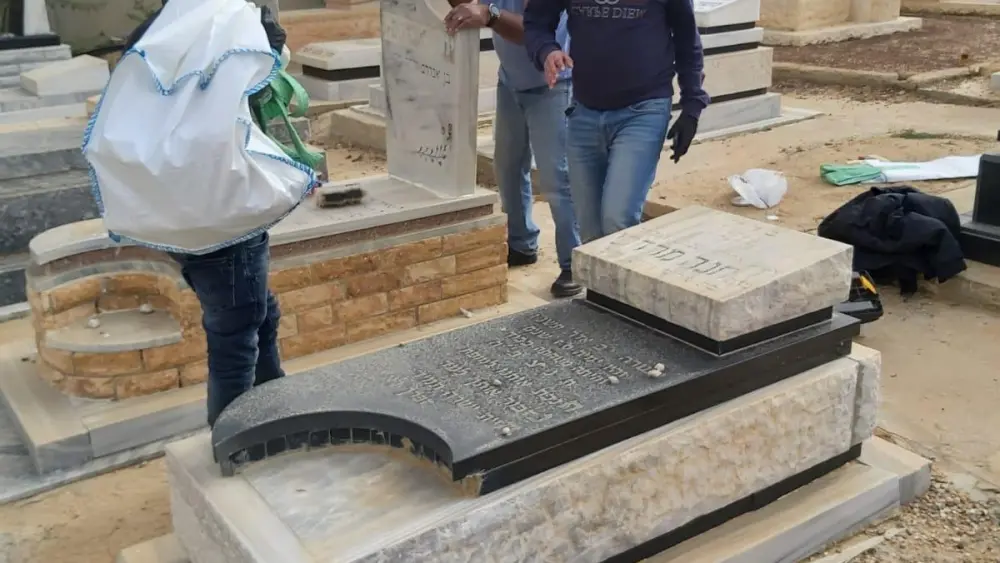 Bedouin men fix broken tombstones at a Jewish cemetery in the Negev Desert. Photo courtesy of Desert Stars.