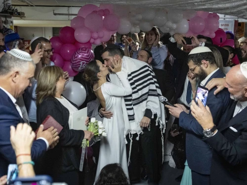 A couple enjoys their wedding ceremony held in an underground parking lot in Tel Aviv used as a protected space amid the war with Iran, March 3, 2026. Photo by Chaim Goldberg/Flash90.