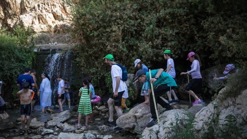 Israelis enjoy their summer holidays at the Ein Meboa Spring in the Prat Stream, Wadi Qelt, south of Jerusalem, on August 16, 2017. Credit: Hadas Parush/Flash90.