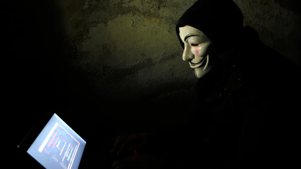 A Palestinian youth wearing a mask associated with the international hacktivist group Anonymous in Jerusalem, April 8, 2013. Photo by Sliman Khader/Flash90.