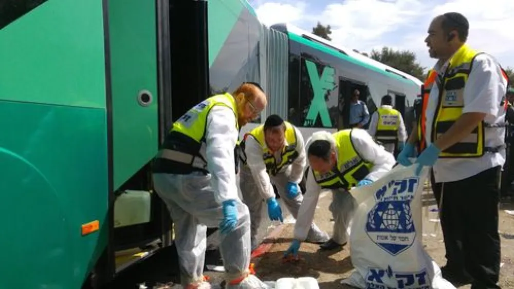 Click photo to download. Caption: Israeli ZAKA volunteers respond to a bus attack in Jerusalem's Geula neighborhood on Oct. 13. Credit: Courtesy ZAKA.
