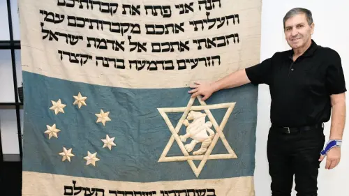 Jewish National Fund chairman Danny Atar displays the newly found “parochet” that covered Theodor Herzl's coffin when the Zionist leader was buried in Israel. Photo by Jorge Novominsky.