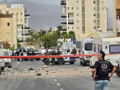 People inspect the damage at the scene where an Iranian missile wounded two civilians and damaged property in Eilat, southern Israel, on March 14, 2026. Photo by Yehuda Ben Itach/Flash90.