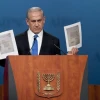 During his Monday night speech at the AIPAC policy conference, Prime Minister Benjamin Netanyahu holds up a copy of letters from 1944, in which the World Jewish Congress had implored the American government to bomb Auschwitz. Credit: EPA/PETE MAROVICH.