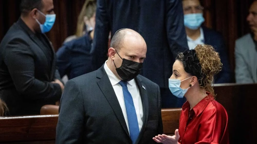 Israeli Prime Minister Naftali Bennett speaks with Knesset member Idit Silman in the plenary hall of the parliament in Jerusalem, Jan. 5, 2022. Photo by Yonatan Sindel/Flash90.