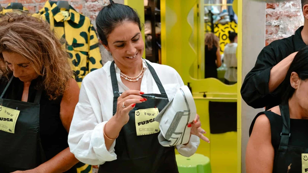Vicki Jan, whose parents were killed in a 2011 terrorist attack, participates in a sneaker painting workshop with orphans from Oct. 7 in Mexico. Photo by Yakir Asaraf.