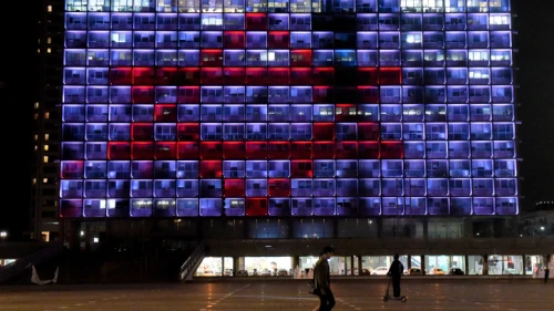 Tel Aviv City Hall on Rabin Square is lit up with a red Magen David Adom to show support for the medical staff battling the coronavirus outbreak in the country, March 30, 2020. Photo by Avshalom Sassoni/Flash90.