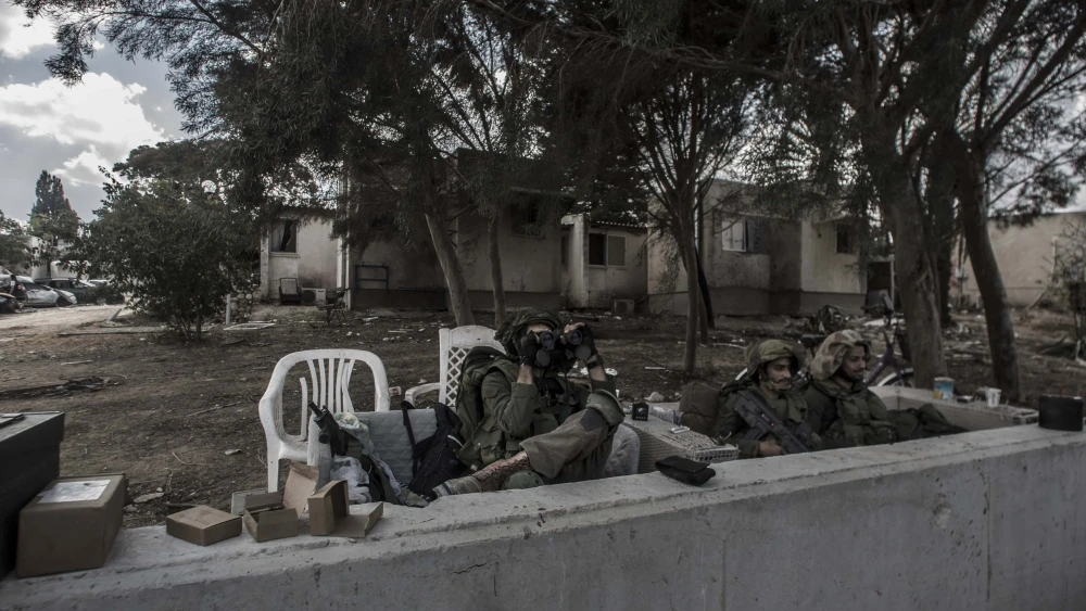 Israeli soldiers stand guard in Kfar Aza in southern Israel after Hamas terrorists rampaged through the community on Oct. 7, murdering families and taking civilians hostage, Oct. 16 2023. Photo by Rina Castelnuovo.