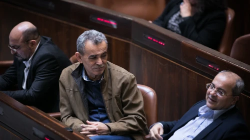 Joint Party Knesset members Jamal Zahalka (center) and Ahmad Tibi (right) attend a plenum session in the assembly hall of the Israeli parliament on Dec. 5, 2016. Photo by Yonatan Sindel/Flash90.