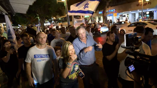 Benny Gantz (center), head of Blue and White Party, mingles with young supporters at a bar on Dizengoff Street in Tel Aviv as part of his election campaign efforts, Aug. 22, 2019. Photo by Gili Yaari/Flash90.