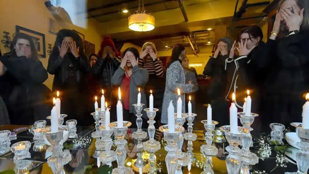 Women and girls light Shabbat candles before the onset of Shabbat on Feb. 22, 2019. Credit: Todd Maisel for Chabad.org/News.