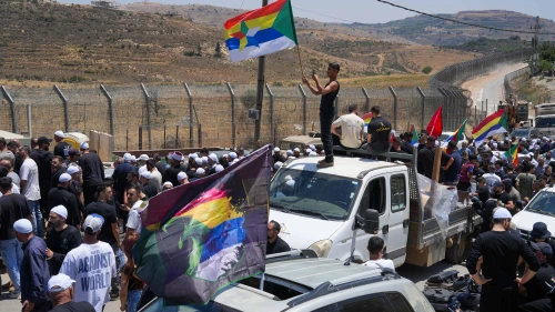 Druze residents protest near the Israeli-Syrian border fence in solidarity with their community in Syria, in Majdal Shams, July 16, 2025. Photo by Ayal Margolin/Flash90.