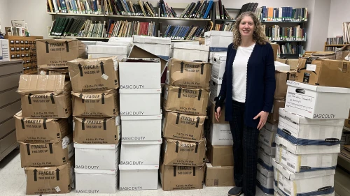 Director of Digital Scholarship Alison Joseph, Ph.D., surveys the mountain of boxes of Elie Wiesel's private collection—the crown jewel of the Grayzel Digital Platform which launches on Thursday, Nov. 6, 2025. Credit: Courtesy.