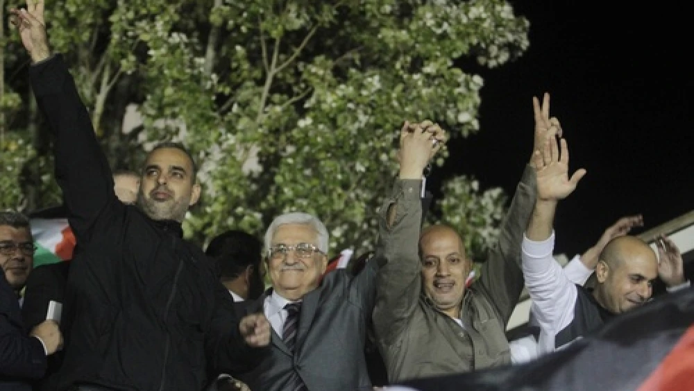 Palestinian Authority leader Mahmoud Abbas (second from left) waves with Palestinian prisoners released from Israeli jails during celebrations in Ramallah, Oct. 30, 2013. Photo by Issam Rimawi/Flash90.