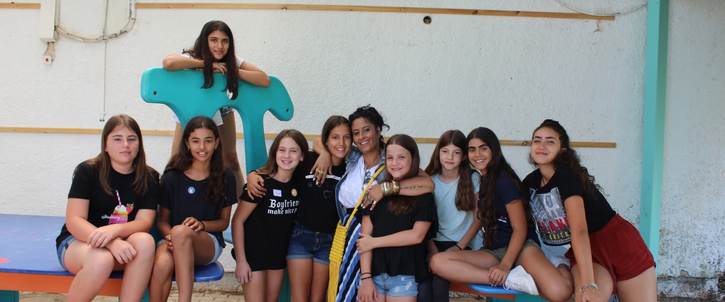 A group of 12-year-olds at the Yuvalei Ha-Bsor School summer camp with their senior adult educator (center) Limor Or, July 2019. Photo by Eric Narrow/JNF.