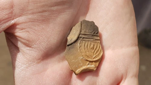 The sherd of the rare oil lamp depicting a menorah. Credit: Anat Rasiuk/Israel Antiquities Authority.