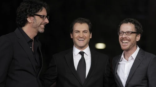 U.S. directors and producers Joel (left) and Ethan Coen pose for photographs with US actor and cast member Michael Stuhlbarg on the red carpet as they arrive at the screening of their film, "A Serious Man" during the 4th annual Rome Film Festival in Italy on Oct. 22, 2009. Credit: EPA/Guida Montani.