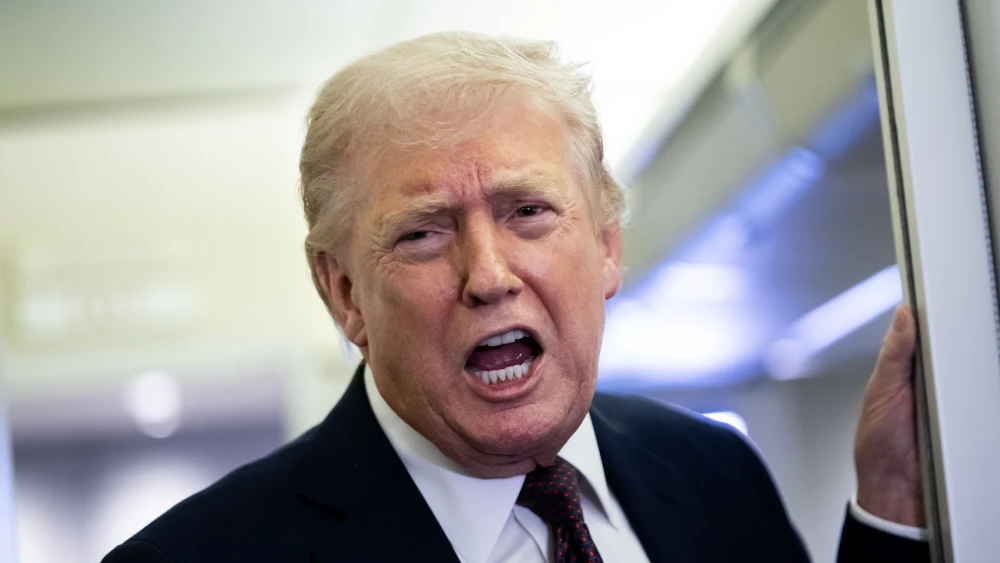 U.S. President Donald Trump speaks to reporters onboard Air Force One on March 15, 2026. Photo by Nathan Howard/Getty Images.