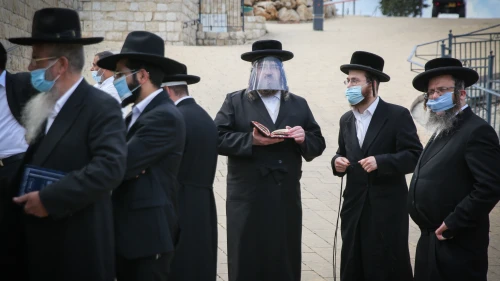 Ultra-Orthodox Jewish men pray in the northern Israeli city of Meron on May 6, 2020. Photo by David Cohen/Flash90.
