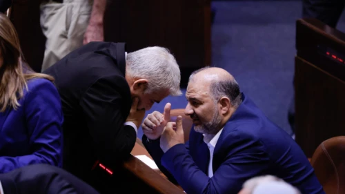 Israeli Foreign Minister Yair Lapid with head of the Ra'am Party, Mansour Abbas, in the Knesset assembly hall on June 21, 2021. Photo by Olivier Fitoussi/Flash90.