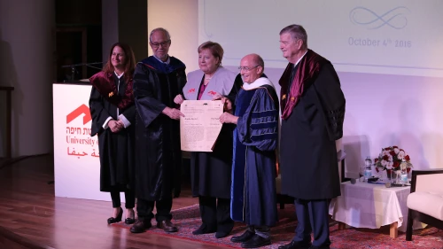 German Chancellor Angela Merkel (center) is presented with an honorary doctorate from the University of Haifa. Credit: University of Haifa.