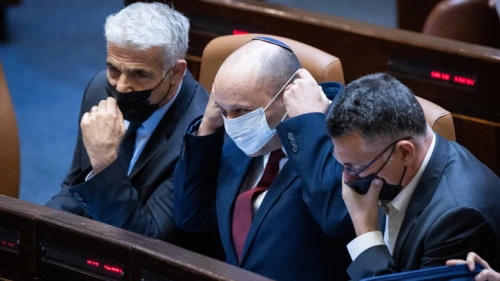 From left: Israeli Foreign Minister Yair Lapid, Prime Minister Naftali Bennett and Justice Minister Gideon Sa'ar attend a Knesset session, on July 6, 2021. Photo by Yonatan Sindel/Flash90.