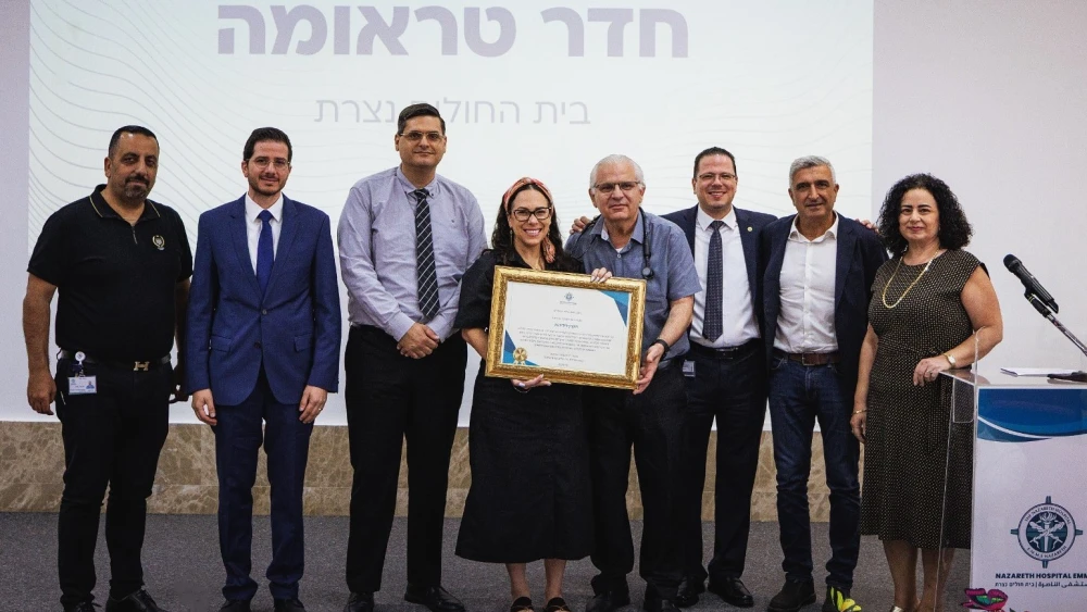 Medical directors and managers at Nazareth Hospital in northern Israel welcome the opening of an expanded and renovated trauma treatment room, which officially started operating in December 2025. Yael Eckstein, president of the International Fellowship of Christians and Jews (IFCJ), holds a certificate marking the summer 2026 event, along with Dr. Najib Nasrallah, head of the ER at Nazareth Hospital. Credit: Courtesy.