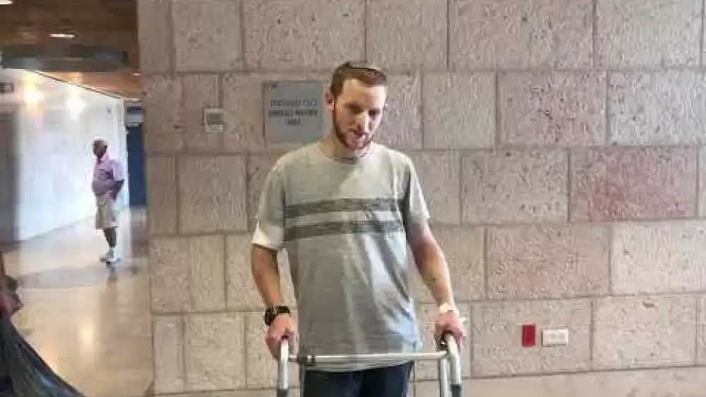 Dvir Shnerb, 19, who was seriously wounded in a terrorist bombing near in Samaria, leaves Hadassah Ein Kerem Hospital in Jerusalem on Sep. 2, 2019. Credit: Screenshot.