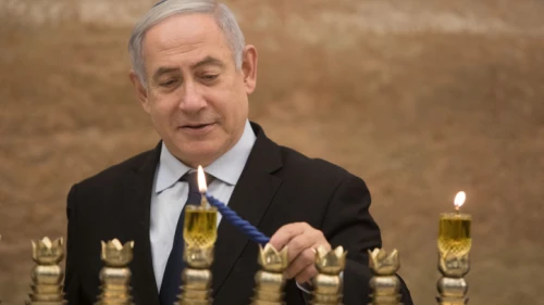 Israeli Prime Minister Benjamin Netanyahu lights a menorah on the first night of the Jewish holiday of Hanukkah at the Western Wall in Jerusalem's Old City on Dec. 22, 2019. Photo by Noam Revkin Fenton/Flash90.