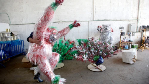 A worker carries a monkey statue made of recycled materials, part of a "Recycled Safari" on display at the Center for Environmental Education in Hiriya near Tel Aviv. March 29, 2012. Photo by Uri Lenz/Flash90.