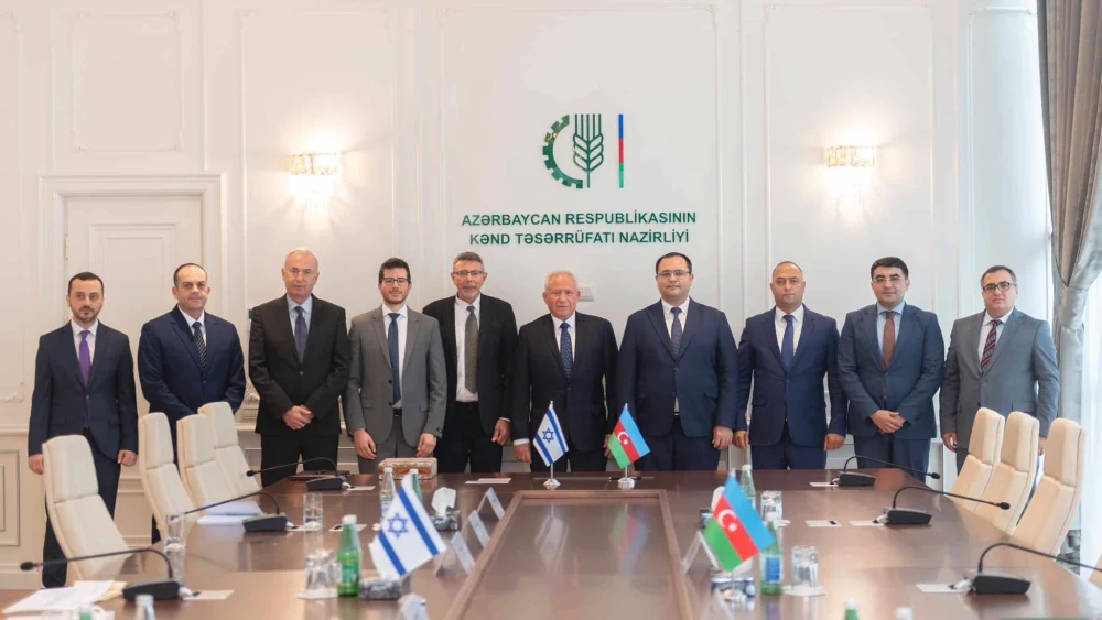 Israeli Agriculture Minister Avi Dichter (center, behind the Israeli flag) at the signing of a declaration of intent regarding wheat production with Azerbaijan, Sept. 11, 2023. Credit Israeli Ministry of Agriculture.