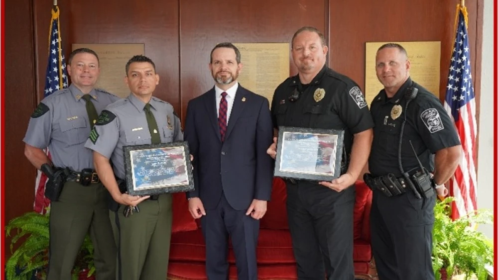 Captain David Malloch, DNR Sgt. Keven Luther on behalf of Officer Luke Robare, U.S. Attorney Jerome G. Gorgon, Jr., Grand Blanc Twp Officer Jason Carpentier and Chief William Renye. Credit: U.S. Justice Department.
