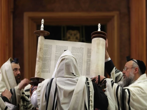Men praying holding Torah